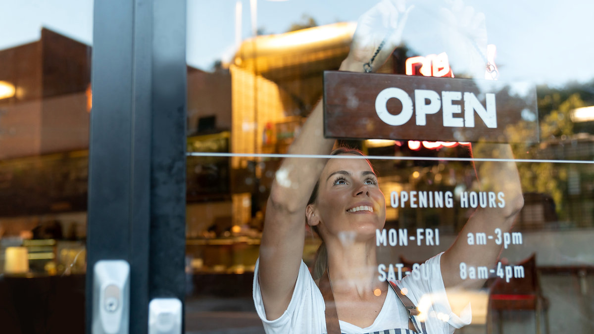 A small business owner opening up shop for the day