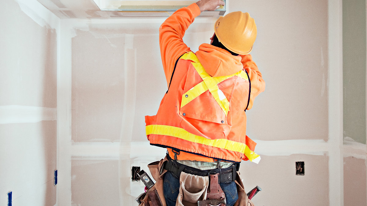 Tradesperson working on site, representing local trades winning work without paying for ads